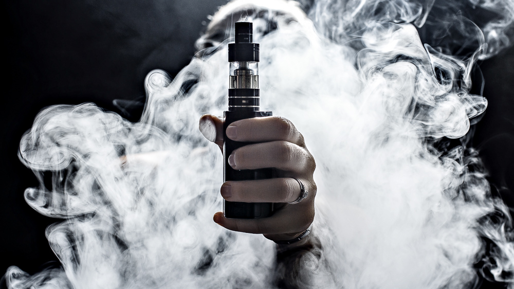 Image of e-cigarette surrounded by vapor. An awareness hashtag had limited impact on growing promotion of vaping among young users: Frontiers in Communication.